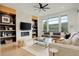 Bright living room with a modern fireplace, built-in shelves and large windows showcasing the outdoors at 3436 W 154Th Ave, Broomfield, CO 80023