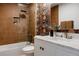 Bathroom with glass-enclosed shower and tub combo, designer floral wallpaper, and updated vanity at 4264 Thorndyke Pl, Broomfield, CO 80020