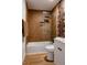 Bathroom featuring glass-enclosed shower and tub combo, decorative floral wallpaper, and modern vanity at 4264 Thorndyke Pl, Broomfield, CO 80020