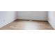 Empty room featuring hardwood floors, white walls, and updated trim at 4264 Thorndyke Pl, Broomfield, CO 80020