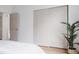 Bedroom with a sliding closet door, complemented by light walls and hardwood floors at 4264 Thorndyke Pl, Broomfield, CO 80020