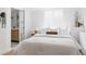 Bright bedroom featuring neutral decor, an ensuite bathroom, and natural light at 4264 Thorndyke Pl, Broomfield, CO 80020