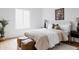 Bright bedroom featuring a cozy queen-sized bed with decorative pillows and hardwood floors at 4264 Thorndyke Pl, Broomfield, CO 80020
