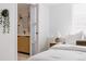 Bright bedroom with an ensuite bathroom, neutral decor, and a large window at 4264 Thorndyke Pl, Broomfield, CO 80020