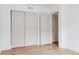 Spacious bedroom featuring hardwood floors, white walls, and a closet at 4264 Thorndyke Pl, Broomfield, CO 80020