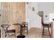 Cozy dining area featuring stylish wood slat partition and seating for four at 4264 Thorndyke Pl, Broomfield, CO 80020