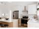 Bright kitchen featuring stainless steel appliances, white countertops, and light wood cabinets at 4264 Thorndyke Pl, Broomfield, CO 80020