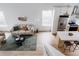 Bright living room with stylish sofa, modern decor, and light wood floors, leading to the kitchen island at 4264 Thorndyke Pl, Broomfield, CO 80020