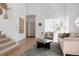 Bright living room featuring neutral furnishings, a gray rug, and an open staircase at 4264 Thorndyke Pl, Broomfield, CO 80020