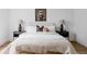 Bright bedroom featuring a queen bed, matching side tables and hardwood floors at 4264 Thorndyke Pl, Broomfield, CO 80020