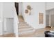 Staircase with carpeted treads and light wood floors leading to the upper level at 4264 Thorndyke Pl, Broomfield, CO 80020