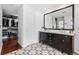 Elegant bathroom featuring a double vanity, patterned tile flooring, and a spacious walk-in closet at 449 S Humboldt St, Denver, CO 80209