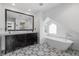 Elegant bathroom with a large vanity, freestanding tub, patterned tile floors, and natural light at 449 S Humboldt St, Denver, CO 80209