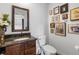 Charming bathroom featuring a vanity with a dark stone countertop, classic mirror, and framed wall art at 449 S Humboldt St, Denver, CO 80209