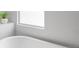 Modern bathroom featuring a sleek bathtub and a bright window for natural light at 449 S Humboldt St, Denver, CO 80209