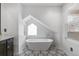 Stylish bathroom featuring a standalone tub, sleek design, and ample natural light from a nearby window at 449 S Humboldt St, Denver, CO 80209
