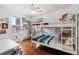 Bright bedroom featuring a wooden floor, bunk bed, work desk, and window with outside view at 449 S Humboldt St, Denver, CO 80209