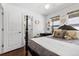 Bedroom with a four-poster bed, hardwood floors, and natural light from the windows, creating a cozy space at 449 S Humboldt St, Denver, CO 80209