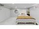 Cozy bedroom with soft carpeting, a comfortable bed, and a round mirror above the headboard at 449 S Humboldt St, Denver, CO 80209