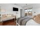 Cozy bedroom with hardwood floors, a plush couch, and a sliding glass door leading to a balcony at 449 S Humboldt St, Denver, CO 80209