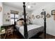 Charming bedroom with a four-poster bed, decorative wall art, and plenty of natural light at 449 S Humboldt St, Denver, CO 80209