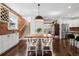 Inviting dining area with a wooden table, modern lighting, and brick accents, adjacent to the kitchen at 449 S Humboldt St, Denver, CO 80209