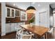 Stylish dining area with a large table, modern lighting, and exposed brick wall accents at 449 S Humboldt St, Denver, CO 80209