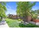 Beautifully landscaped front yard showcases a charming brick two-story home with mature shade trees at 449 S Humboldt St, Denver, CO 80209
