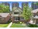 Attractive two-story home with a blend of brick and stucco, complemented by lush greenery at 449 S Humboldt St, Denver, CO 80209