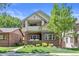 Charming two-story home featuring a brick facade, balcony, and well-maintained landscaping at 449 S Humboldt St, Denver, CO 80209