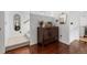 Hallway featuring a decorative wooden cabinet, mirrors, and stairs leading to another floor at 449 S Humboldt St, Denver, CO 80209
