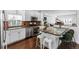 Modern kitchen with stainless steel appliances, white cabinetry, and a stylish island with seating at 449 S Humboldt St, Denver, CO 80209