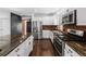 Spacious kitchen featuring brick backsplash, stainless steel appliances, and a large island with bar seating at 449 S Humboldt St, Denver, CO 80209
