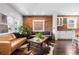 Cozy living area with exposed brick, large windows, hardwood floors, and comfortable seating at 449 S Humboldt St, Denver, CO 80209