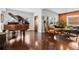 Inviting living area showcasing hardwood floors, a grand piano, and exposed brick accents at 449 S Humboldt St, Denver, CO 80209