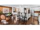 Open-concept living space with a modern kitchen, hardwood floors, and exposed brick detail at 449 S Humboldt St, Denver, CO 80209