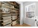 Walk-in pantry featuring adjustable shelves, containers, and storage for cleaning supplies and food at 449 S Humboldt St, Denver, CO 80209