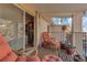 The balcony features comfortable seating, a stylish rug, and views of the outdoors at 13635 E Bates Ave # 406, Aurora, CO 80014