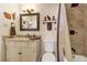 Cozy bathroom boasting tiled shower, framed mirror, and vanity with white cabinets at 13635 E Bates Ave # 406, Aurora, CO 80014