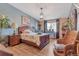 Comfortable bedroom with hardwood floors, stylish lighting, and a view, creating a relaxing private retreat at 13635 E Bates Ave # 406, Aurora, CO 80014