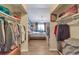 Bright bedroom featuring hardwood floors, a ceiling fan, and dual walk-in closets at 13635 E Bates Ave # 406, Aurora, CO 80014