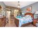 Tranquil bedroom with wood accent wall, walk-in closet, and warm lighting, designed for optimal relaxation and comfort at 13635 E Bates Ave # 406, Aurora, CO 80014