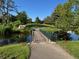 Picturesque bridge over a pond, leading to a green lawn on a sunny day at 13635 E Bates Ave # 406, Aurora, CO 80014