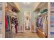 Spacious walk-in closet with custom shelving and racks, optimizing storage and organization, adjoins a bathroom at 13635 E Bates Ave # 406, Aurora, CO 80014