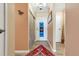 Inviting entryway featuring stylish sliding door closet and colorful accent rug at 13635 E Bates Ave # 406, Aurora, CO 80014