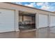 An open garage with interior storage shelves and units plus a concrete floor with melting ice at 13635 E Bates Ave # 406, Aurora, CO 80014