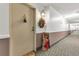 Well-lit hallway with neutral carpet and decor, creating a welcoming entrance to unit at 13635 E Bates Ave # 406, Aurora, CO 80014