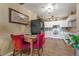 Well-lit kitchen with white cabinets, tile backsplash, and space for a dining table next to stainless steel appliances at 13635 E Bates Ave # 406, Aurora, CO 80014