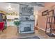 Open-concept living room with stone fireplace, modern lighting, and seamless flow to the kitchen at 13635 E Bates Ave # 406, Aurora, CO 80014