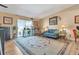 Bright living room with large rug and sliding glass door to balcony at 13635 E Bates Ave # 406, Aurora, CO 80014